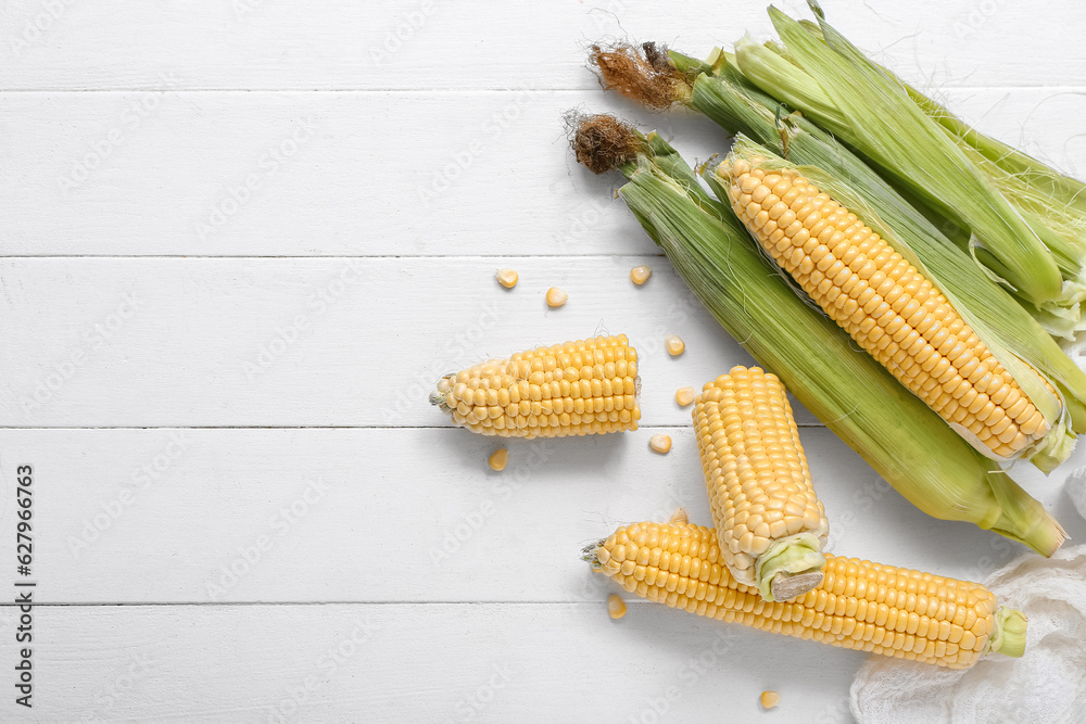 Fresh corn cobs on white table