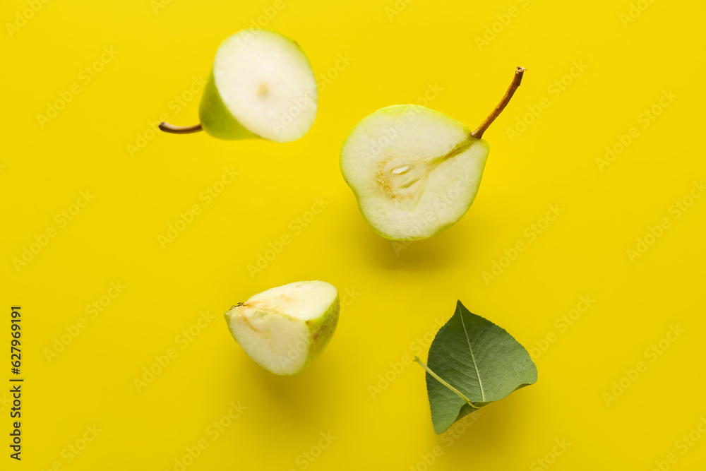 Flying ripe pears on yellow background