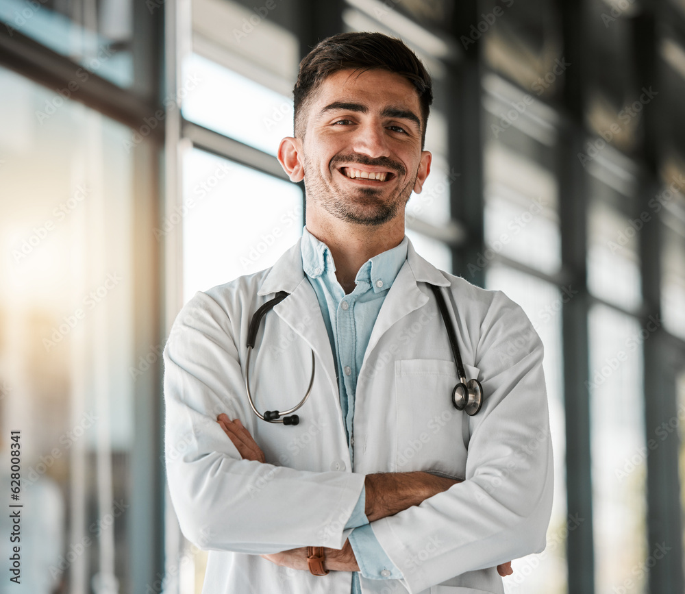 Crossed arms, confidence and portrait of a male doctor with a stethoscope in a medical hospital. Hap