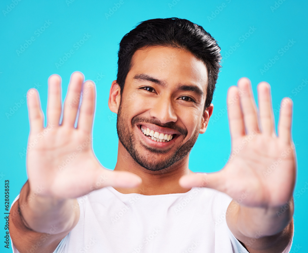 Portrait, hands and man frame face in studio to review profile picture on blue background. Happy you