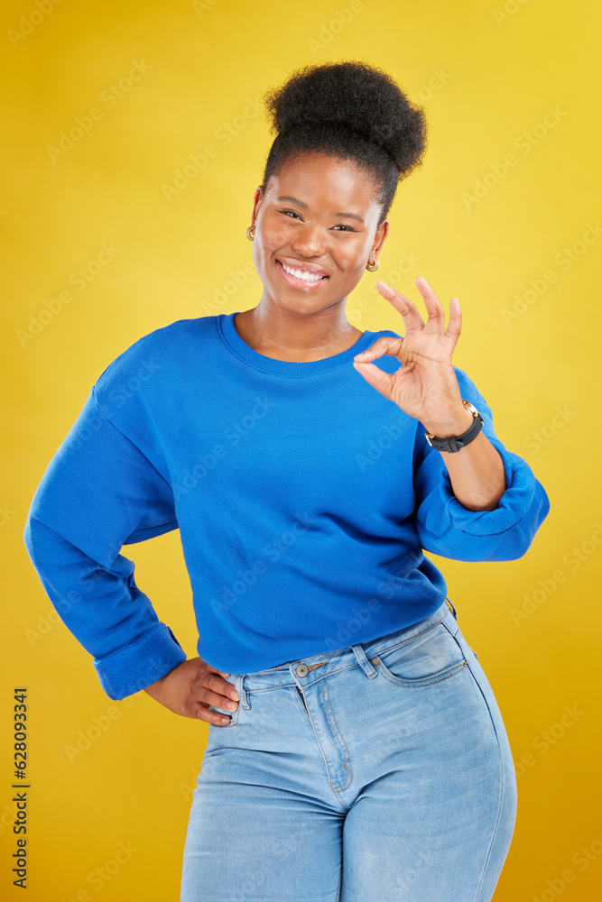 Portrait, black woman and ok sign with a smile, review and feedback against a yellow studio backgrou