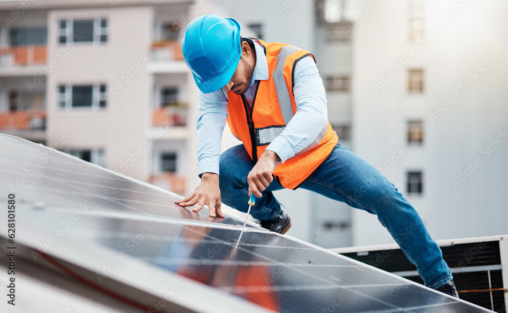 Technician man, screwdriver and solar panel on roof for maintenance, industry and construction in ci