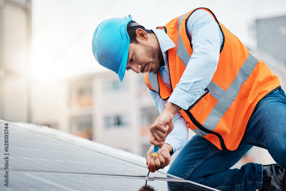 Solar panels, tool and male engineer on a rooftop doing maintenance or repairs with screwdriver. Ren