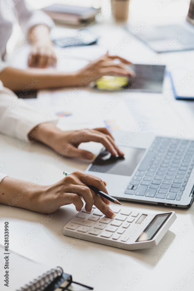 Businesswoman colleague discuss planning, budget management, accounting, business in office.