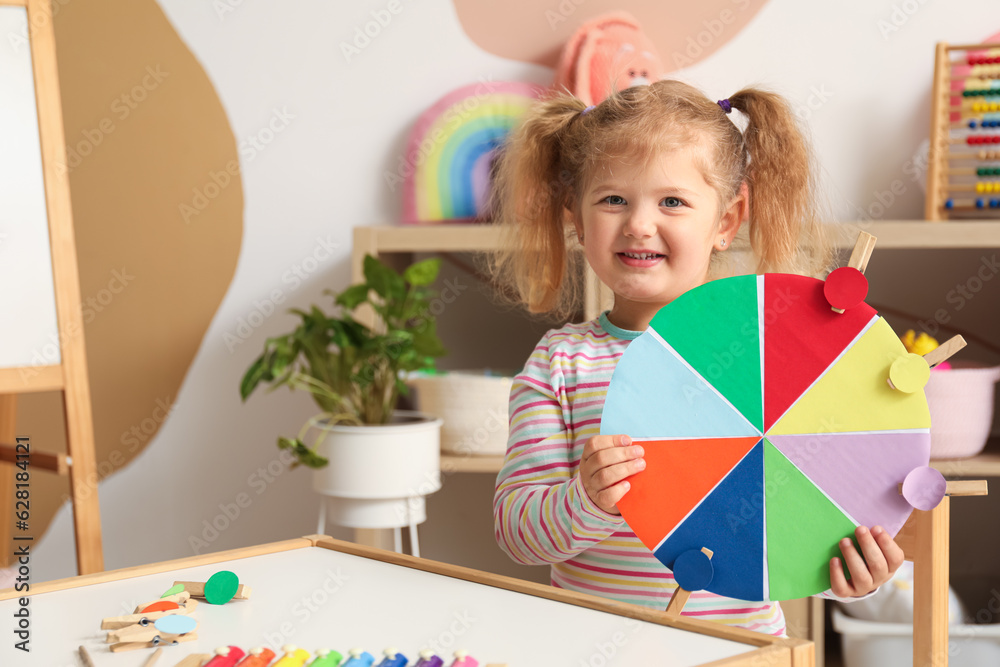 Cute little girl with matching game at home