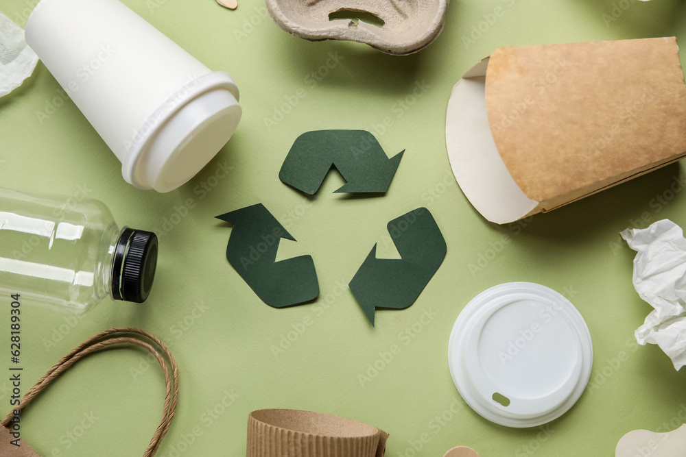 Recycling sign with garbage on green background