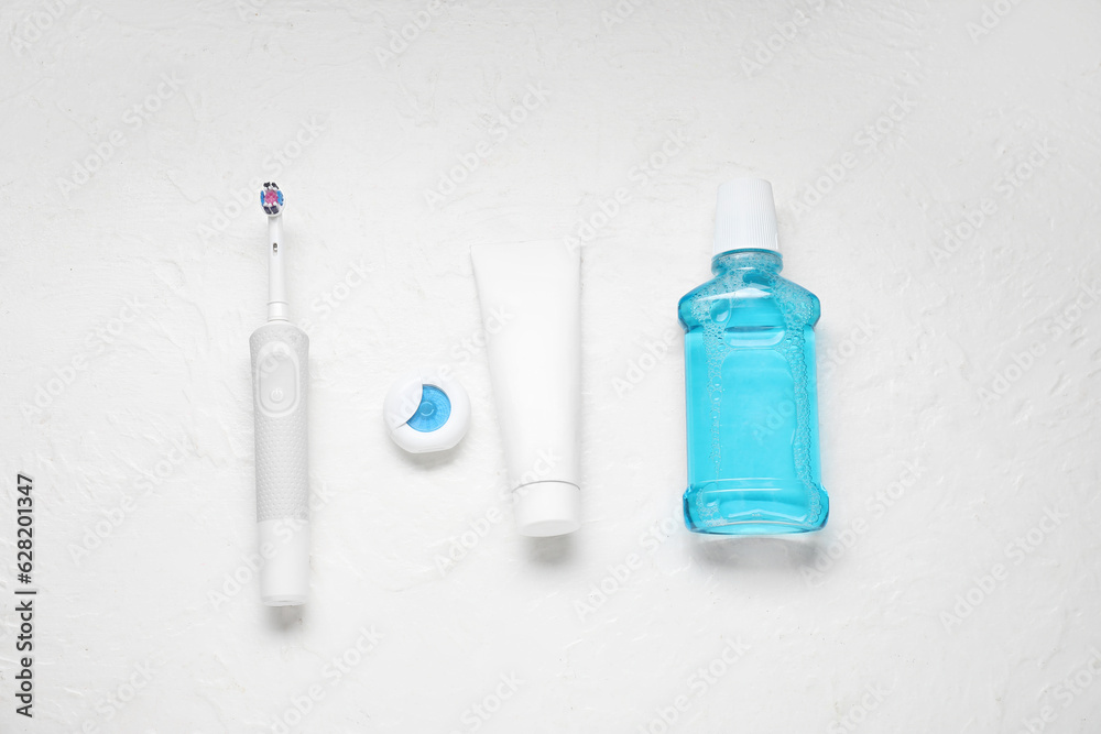 Set for oral hygiene on textured white background