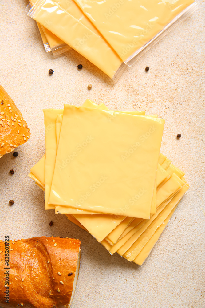 Slices of tasty processed cheese on light background