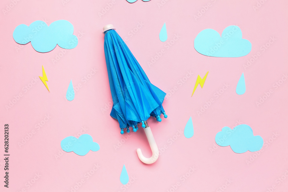 Umbrella with paper clouds, rain drops and lightnings on pink background. Weather forecast concept