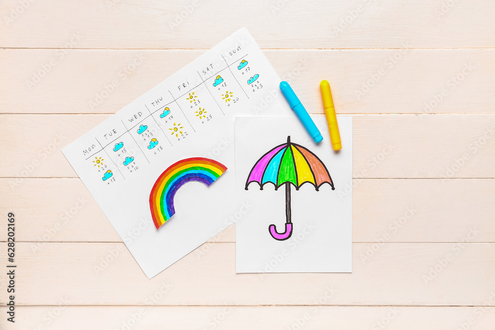 Paper with weekly weather forecast and drawn umbrella on white wooden background