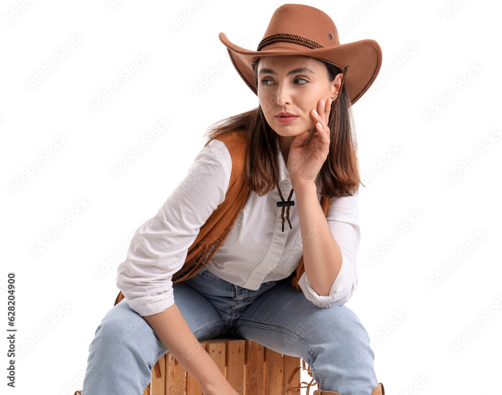 Beautiful cowgirl sitting on white background