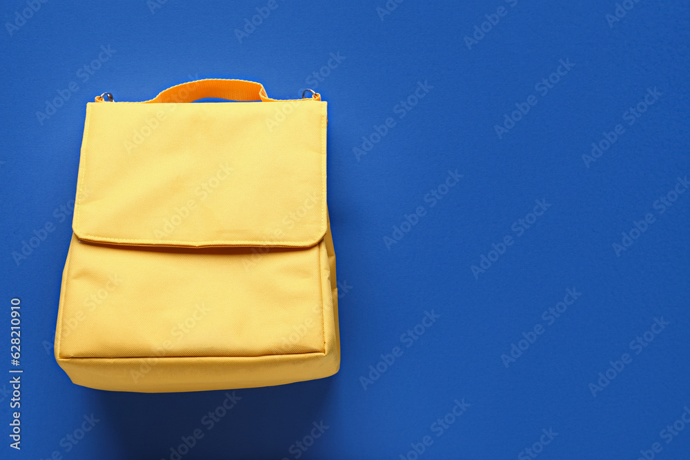 Yellow lunch box bag on blue background