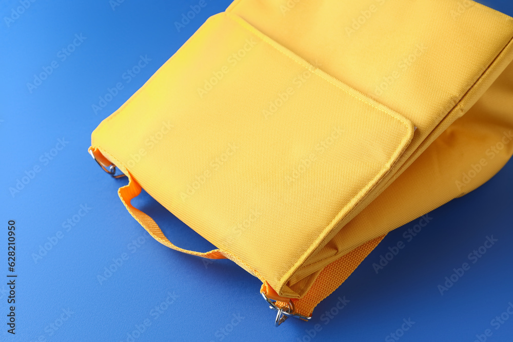 Yellow lunch box bag on blue background