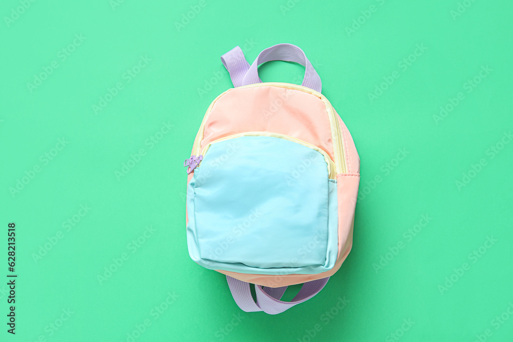 Color school backpack on green background