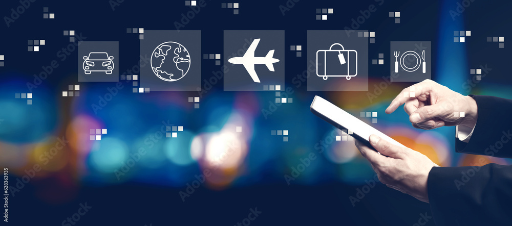 Airplane travel theme with businessman using a tablet computer at night