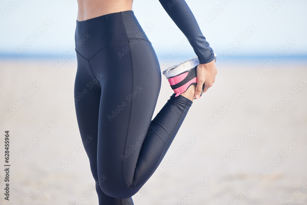 Woman, fitness and stretching legs for running, training or outdoor exercise on the beach. Female pe