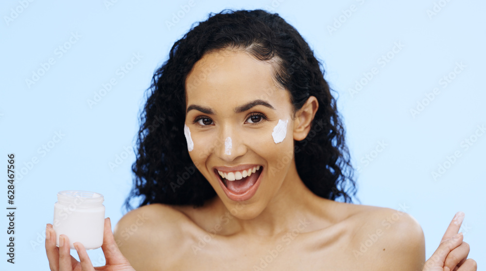 Face, cream and beauty of woman with cosmetics, smile and sunscreen on blue background. Facial skinc