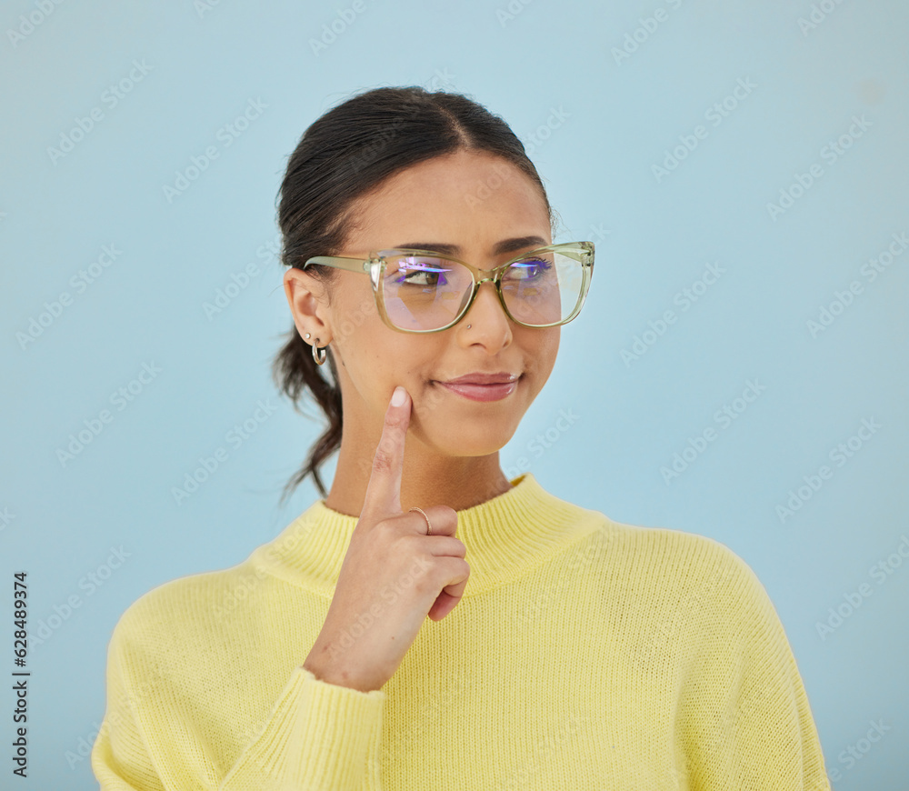 Woman, smile and glasses in studio thinking, problem solving style and vision on blue background. Id