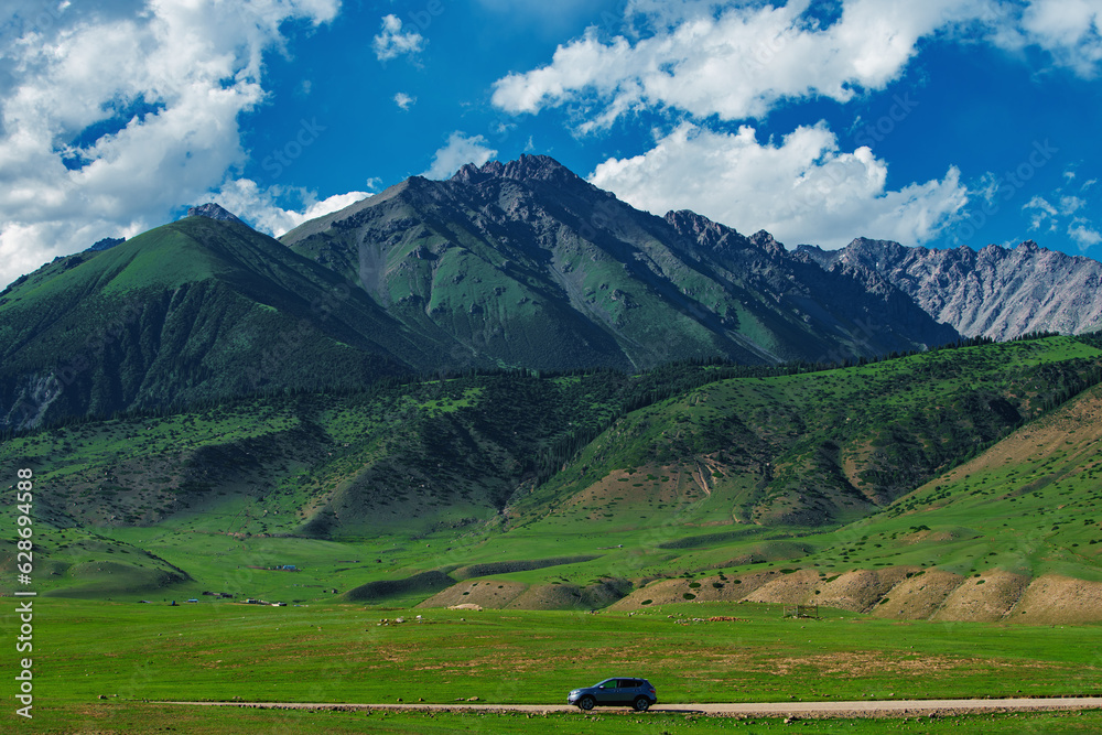 Car driving on a mountain road on a sunny summer day