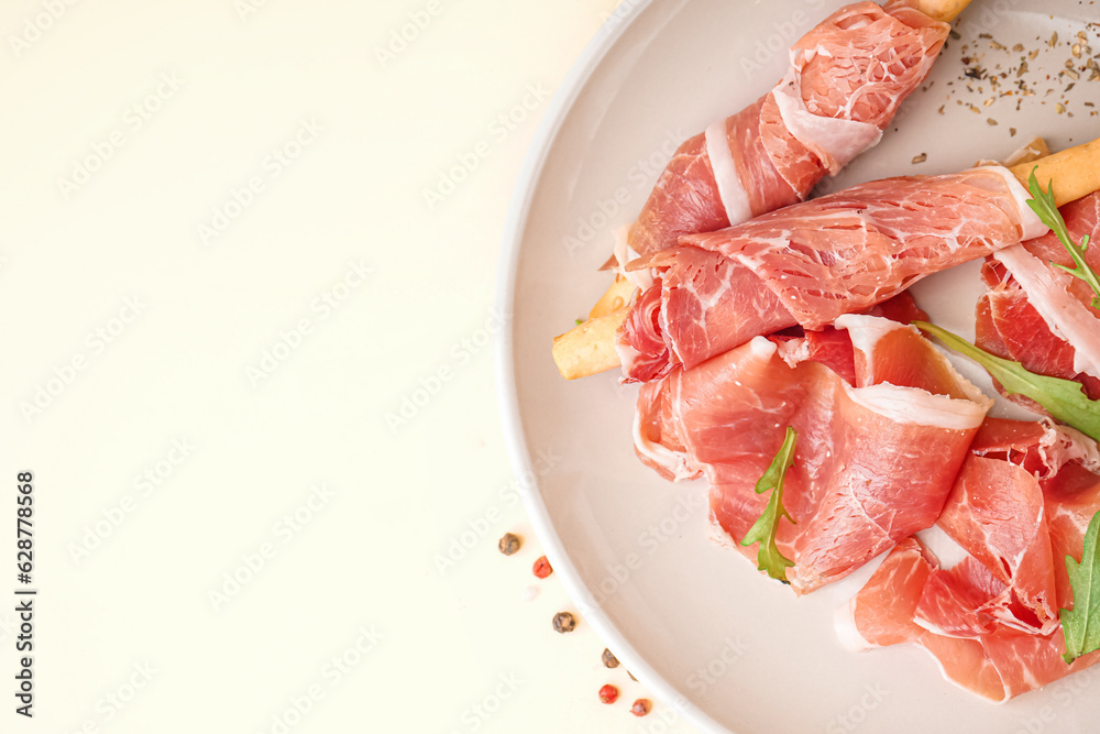 Plate with slices of tasty jamon on yellow background, closeup