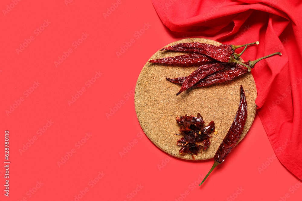 Composition with dry hot chili peppers on red background