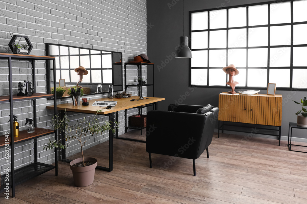 Interior of beauty salon with comfortable armchair, table and mirror