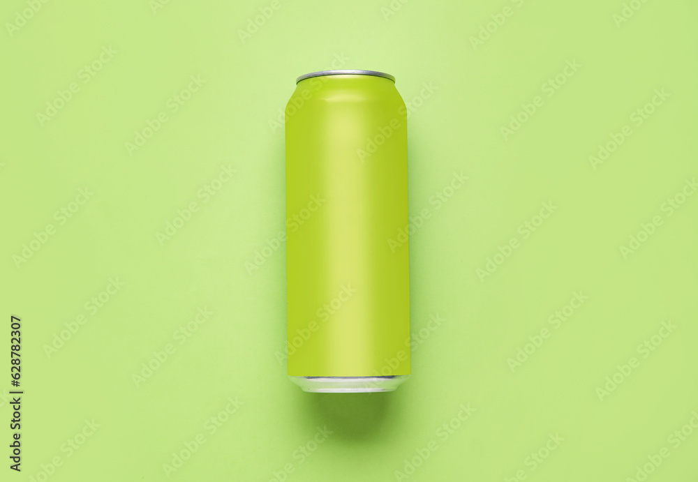 Can of soda on green background