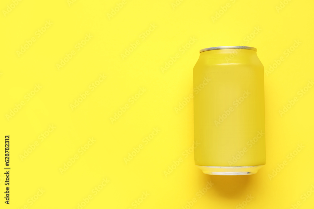 Can of soda on yellow background