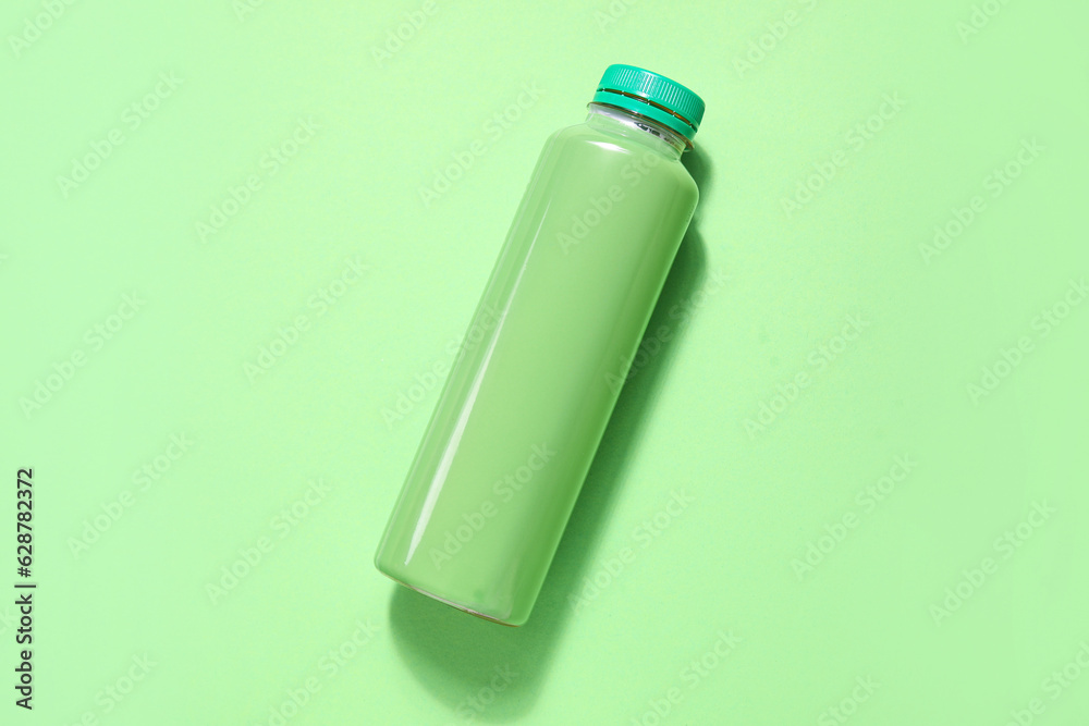 Bottle of fresh soda on green background