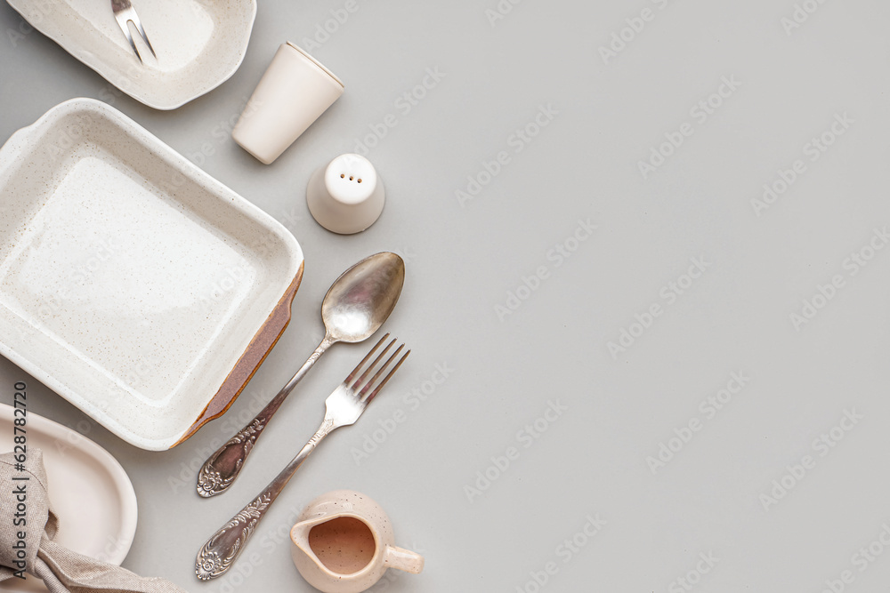 Set of stylish tableware on grey background