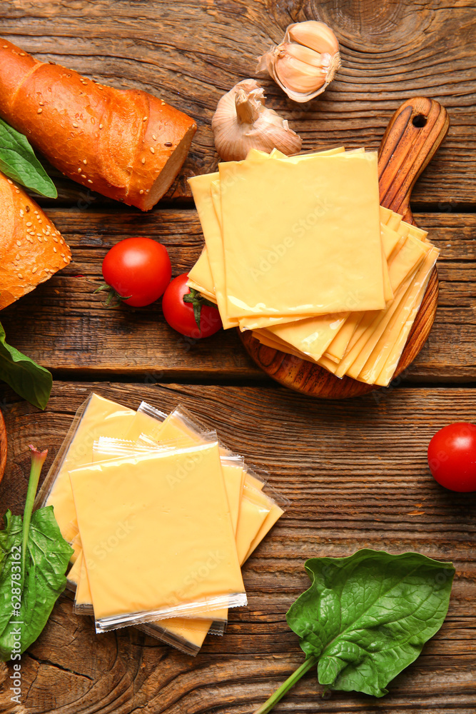 Board with slices of tasty processed cheese, bread and tomatoes on wooden background