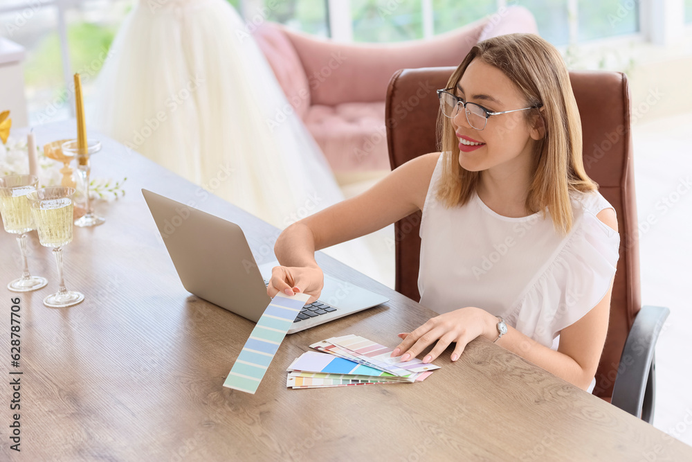 Female wedding planner working with color palettes in office