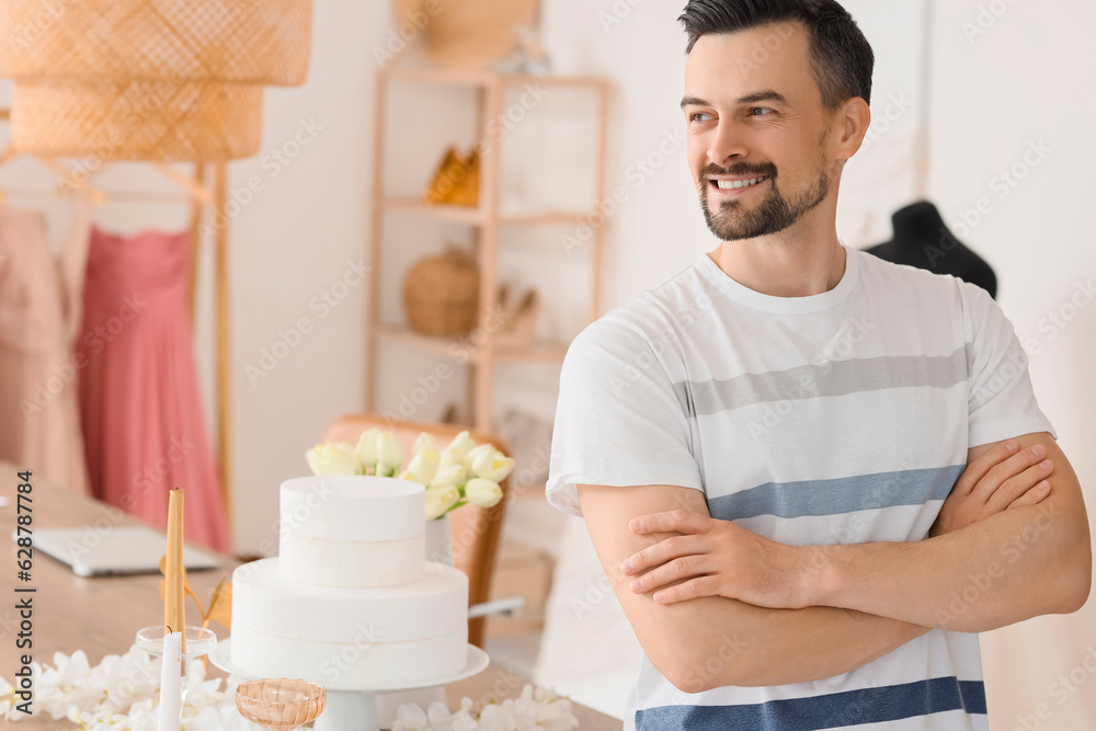 Male wedding planner working in office