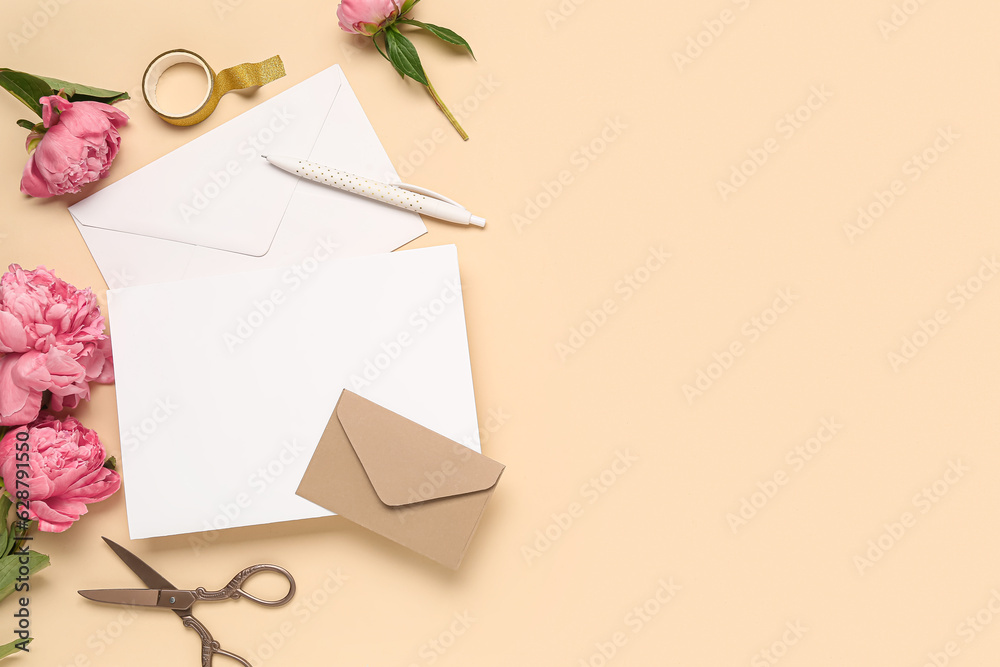 Composition with blank card, beautiful peony flowers, scissors and envelopes on color background