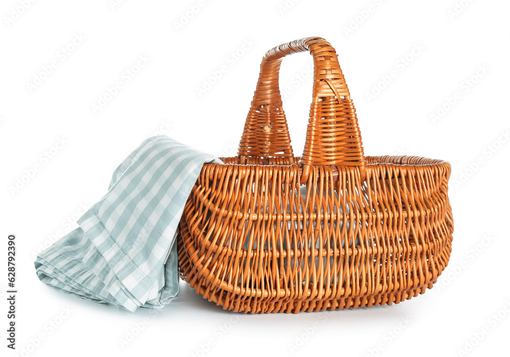 Wicker picnic basket with napkin on white background