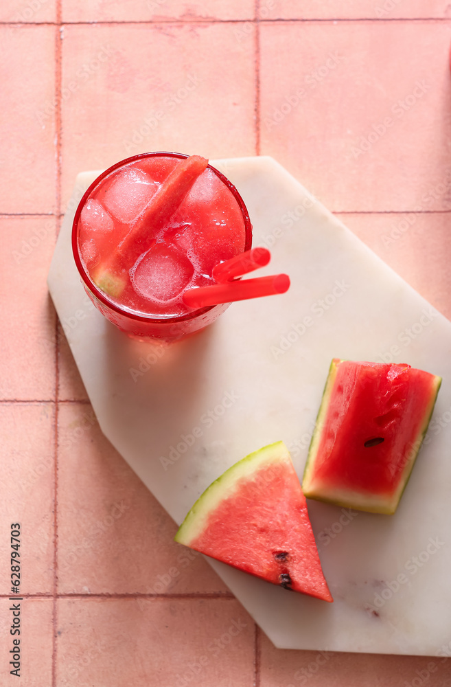 Glass of tasty watermelon fresh on beige tile background