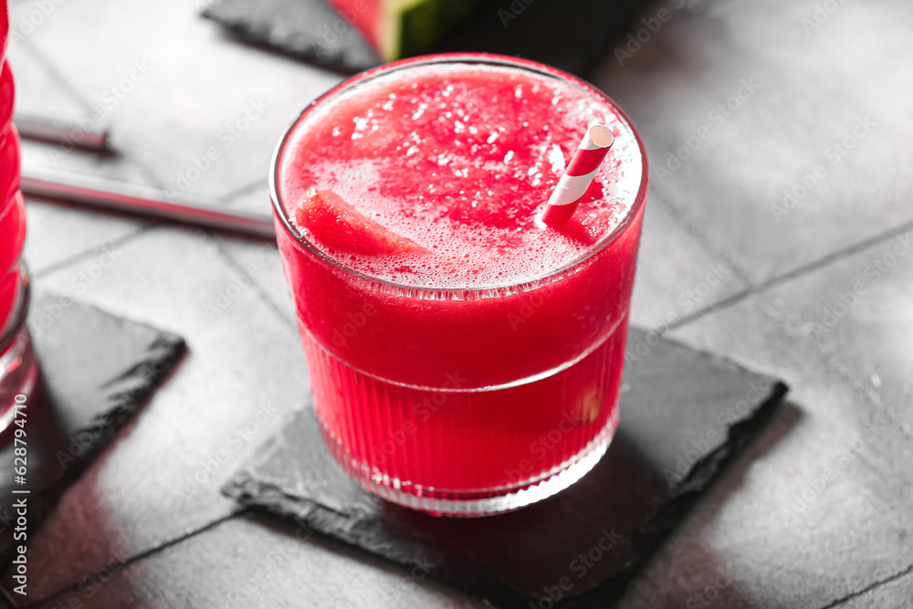 Glass of tasty watermelon fresh on grey tile background