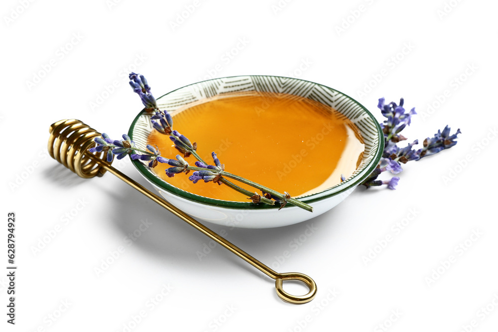 Bowl of sweet lavender honey, dipper and flowers on white background