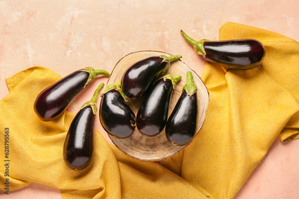 Wooden stand with fresh eggplant on light background