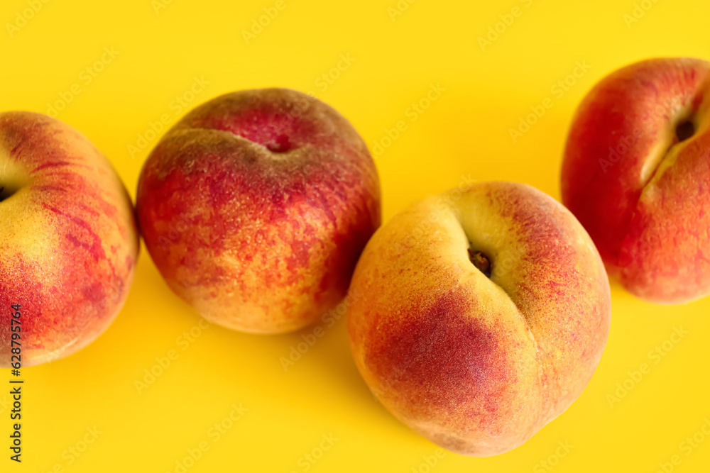 Sweet peaches on yellow background