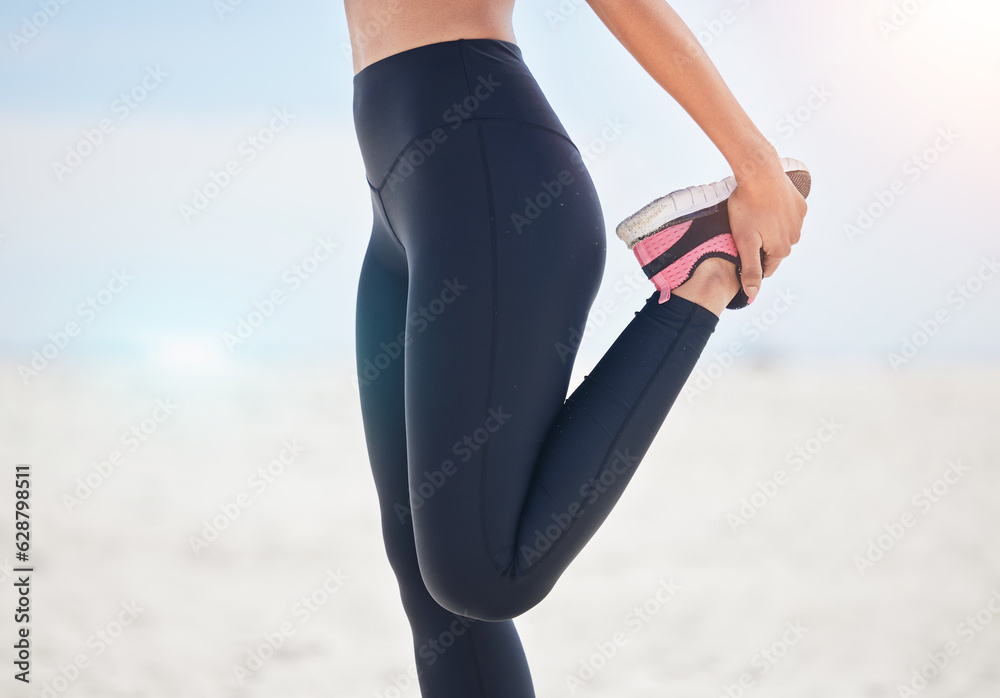 Fitness, woman and stretching leg at a beach for running, workout and body, exercise or wellness rou