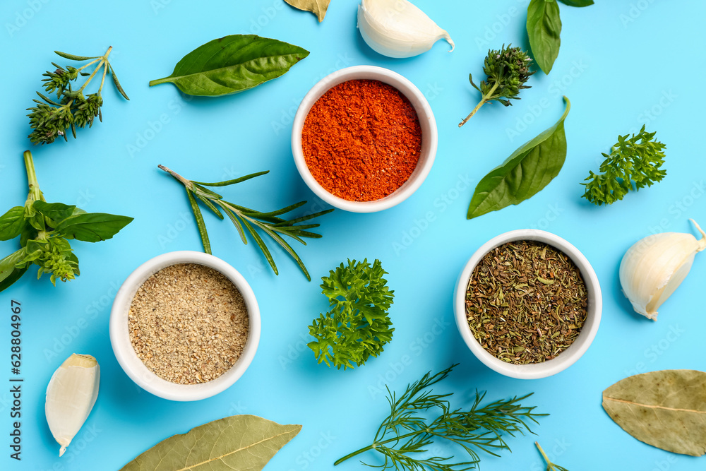 Composition with bowls of fresh aromatic spices and herbs on color background