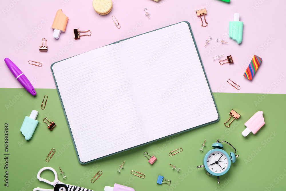 Notebook with different stationery supplies on colorful background