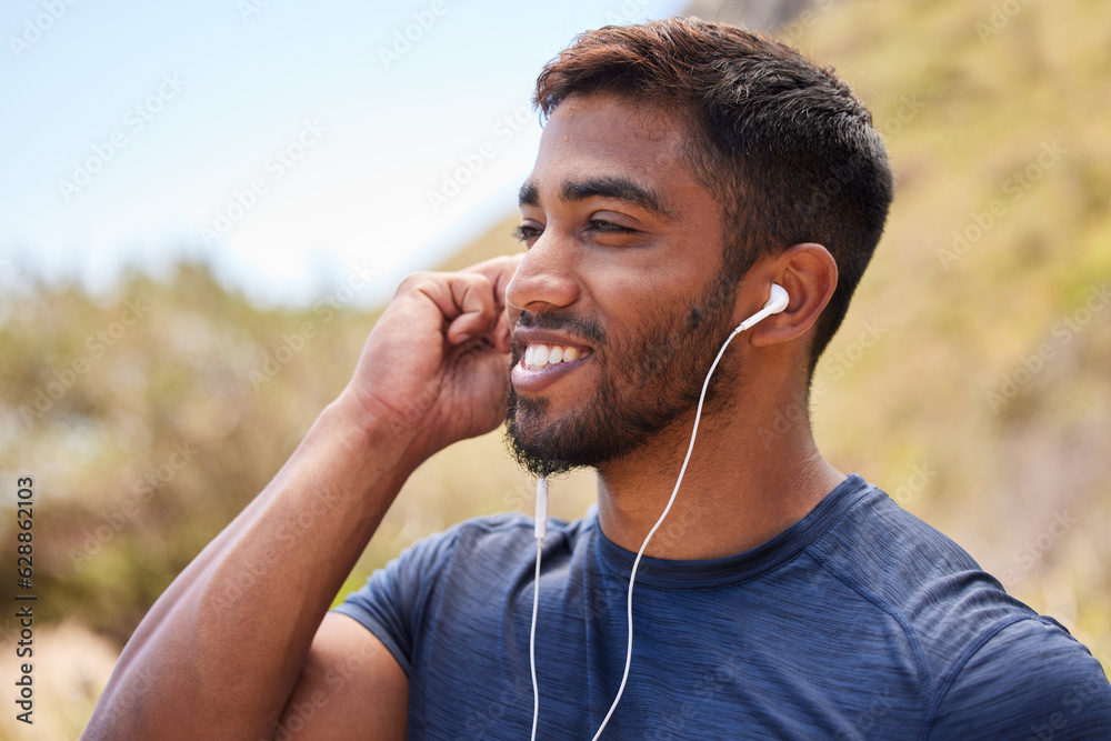 Fitness, happy man or runner with music in training, wellness or cardio exercise outdoors in nature.