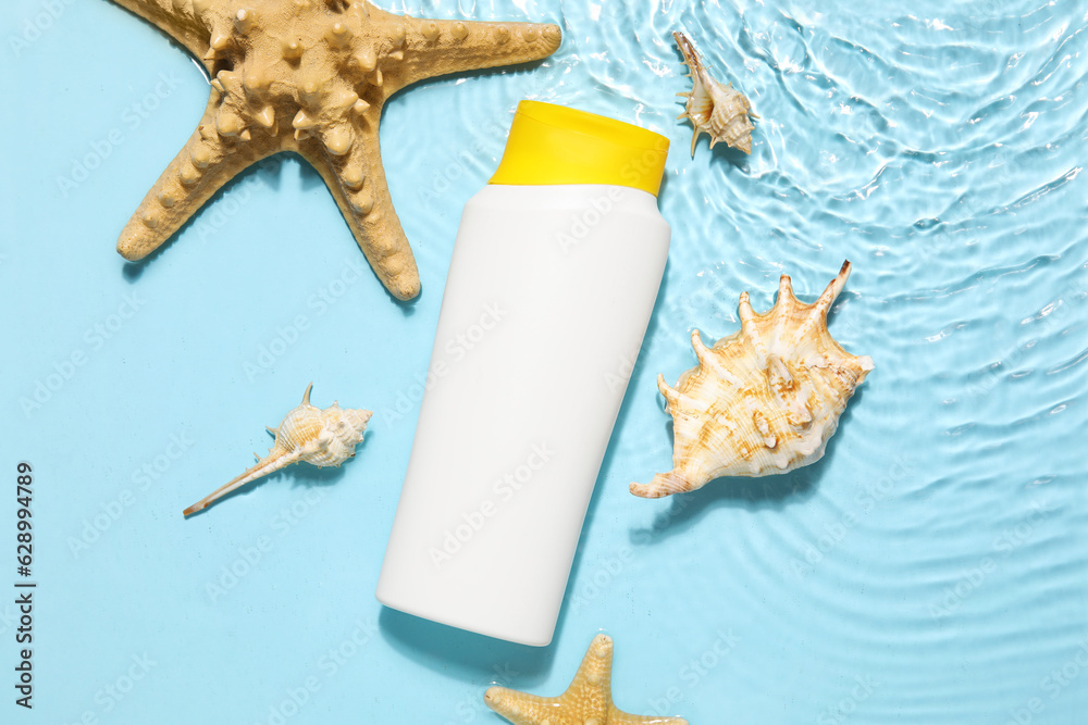 Sunscreen cream with starfishes and seashells in water on color background