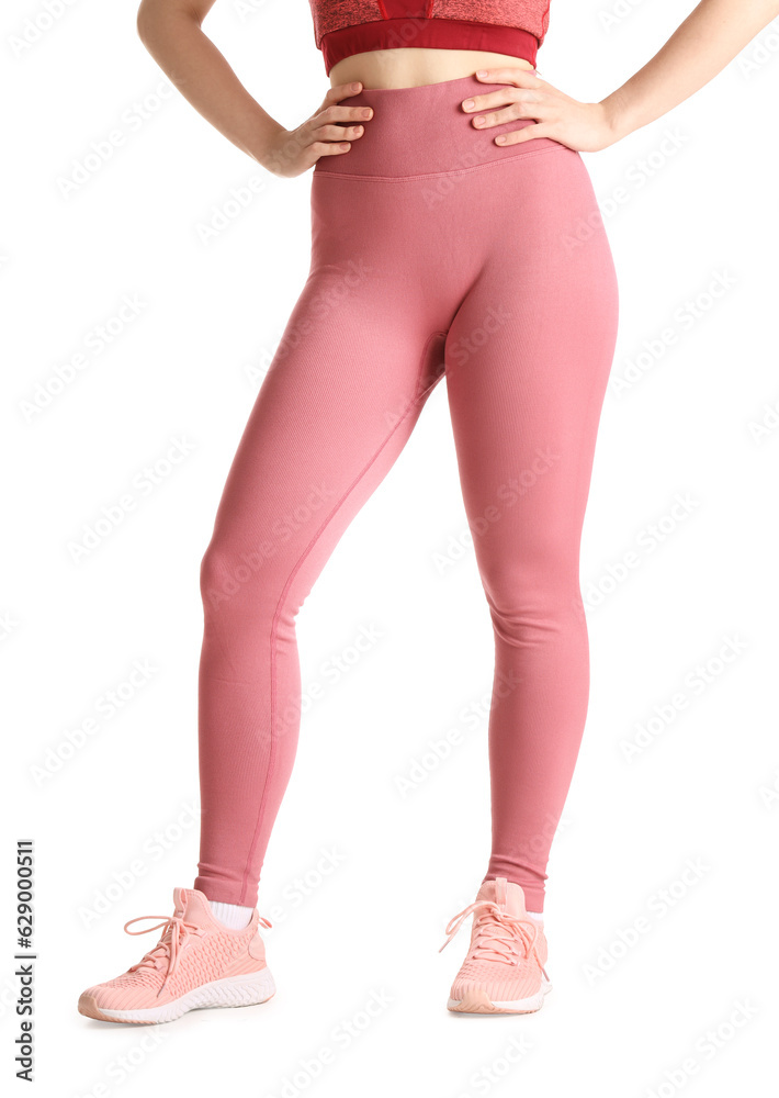 Sporty young woman in leggings on  white background