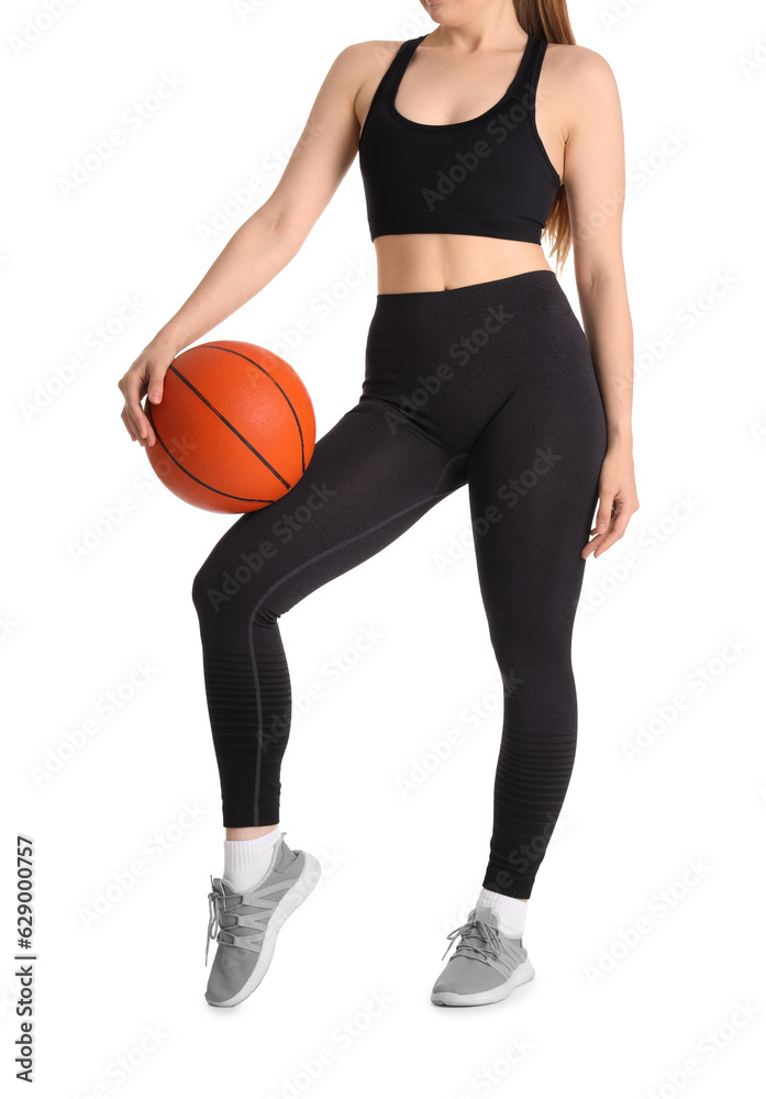 Young woman in sportswear and with ball on white background