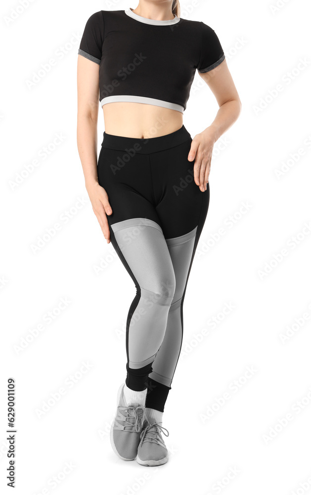 Young woman in sportswear on white background