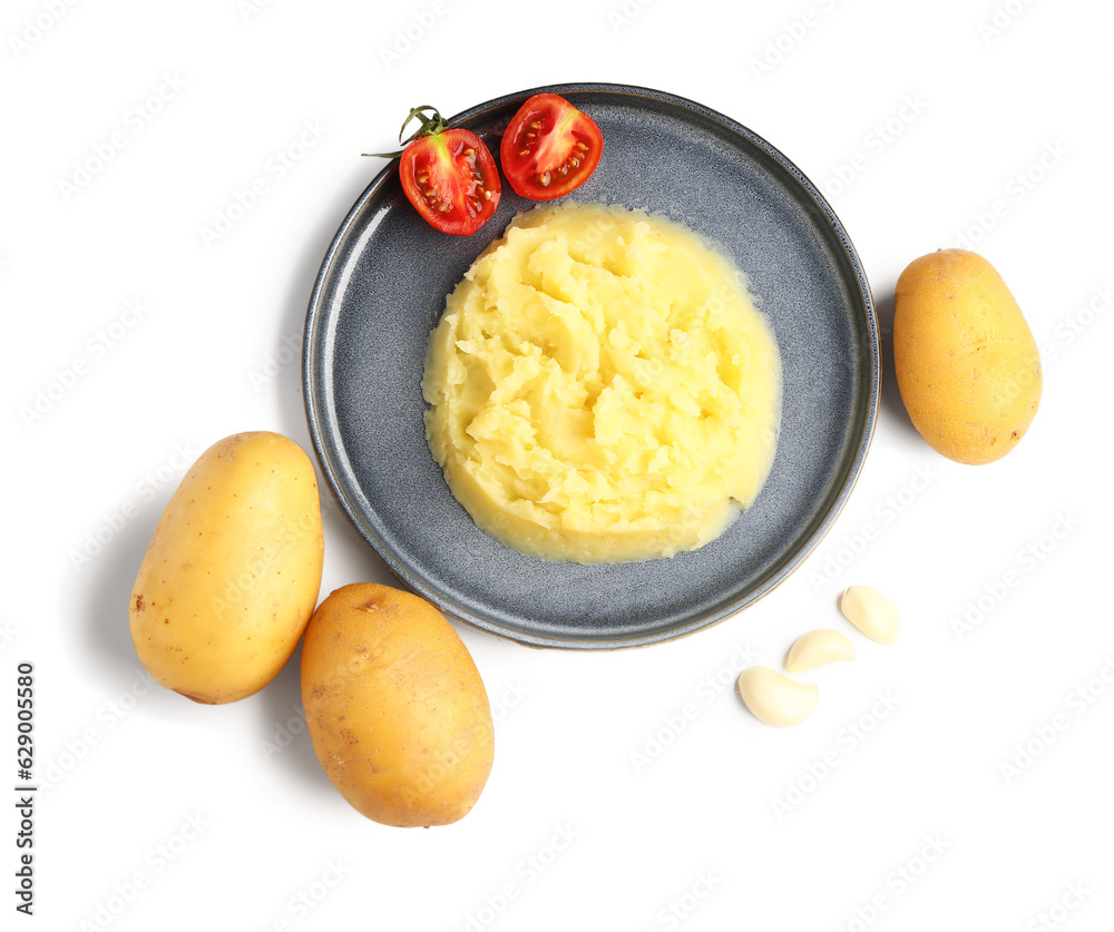 Plate of tasty mashed potatoes with tomato and garlic on white background