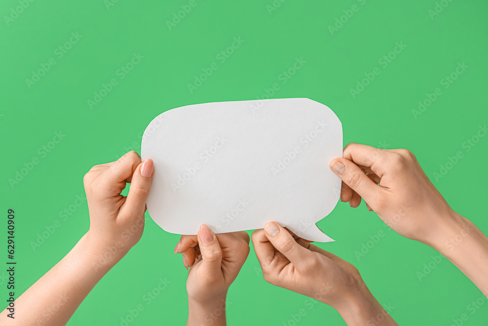 Female hands with speech bubble on green background